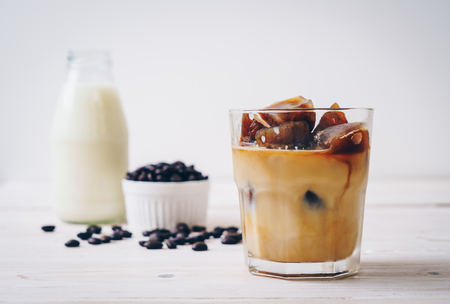 coffee ice cubes with milk on wood tableの写真素材