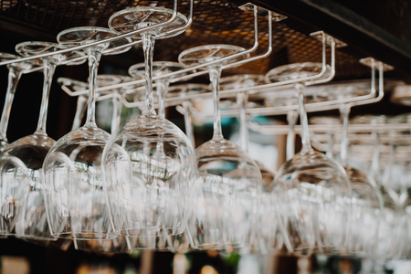 wine glass hanging on shelf - selective focus pointの写真素材