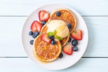 souffle pancake with blueberries, strawberries, honey and vanilla ice-creamの写真素材