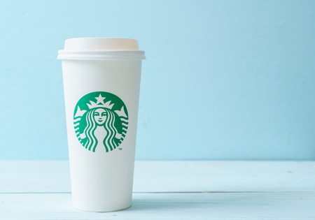 BANGKOK, THAILAND - JUN 5, 2018: White coffee cup with Starbucks logo on wood background. Starbucks is the world's largest coffee house with over 20,000 stores in 61 countries.のeditorial素材