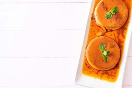 homemade caramel custard pudding on wood backgroundの写真素材