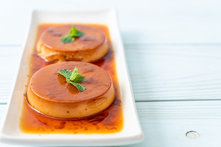 homemade caramel custard pudding on wood background