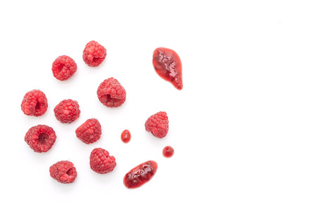 fresh raspberries  with raspberry jam or sauce isolated on white backgroundの写真素材