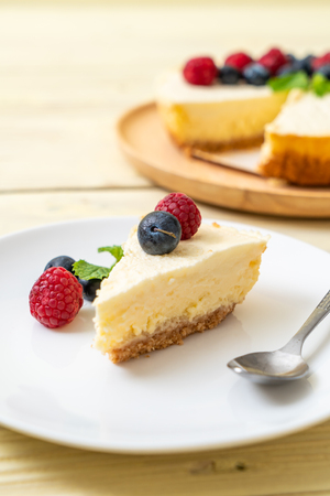 Homemade cheesecake with fresh raspberries and blueberriesの写真素材