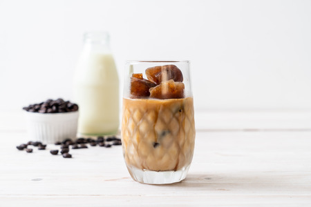 coffee ice cubes with milk on wood tableの写真素材