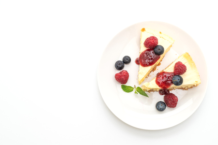 Homemade cheesecake with raspberries and blueberries isolated on white backgroundの写真素材