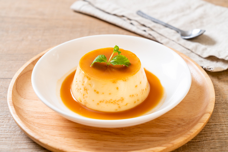 homemade caramel custard pudding with mintの写真素材