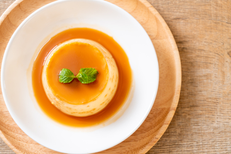 homemade caramel custard pudding with mintの写真素材