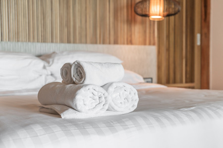 White towel on bed in hotel and resortの写真素材