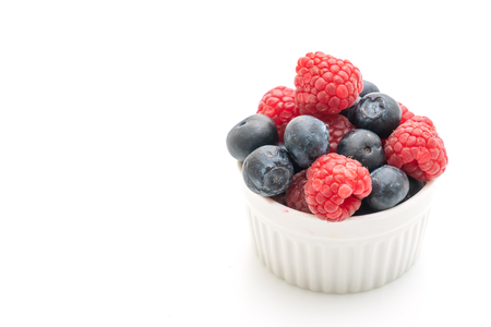 fresh raspberries and fresh blueberries isolated on white backgroundの写真素材