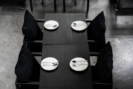 plate with spoon and fork on dining table in restaurant and cafe