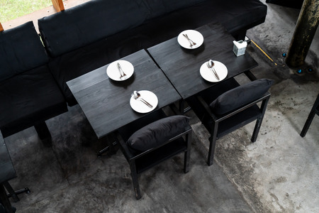 plate with spoon and fork on dining table in restaurant and cafeの写真素材