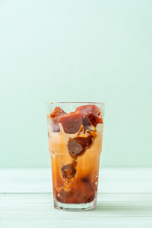Thai tea ice cube with milk on wood backgroundの写真素材
