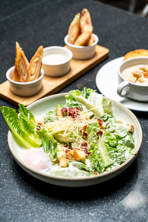 Caesar salad bowl with egg - healthy food styleの写真素材