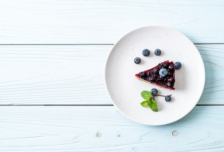 homemade blueberry cheese cake on wood background