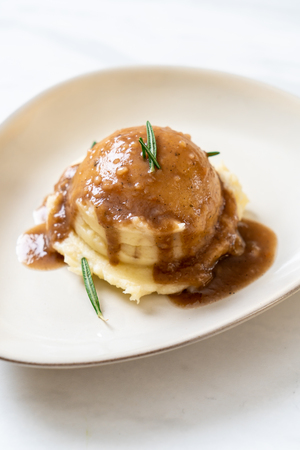 homemade mashed potatoes with gravy sauceの写真素材