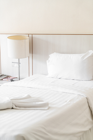 Comfortable pillow on bed decoration in hotel bedroom interiorの写真素材