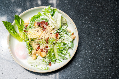 Caesar salad bowl with egg - healthy food styleの写真素材