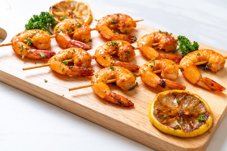 Grilled tiger shrimps skewers with lemon - seafood styleの写真素材