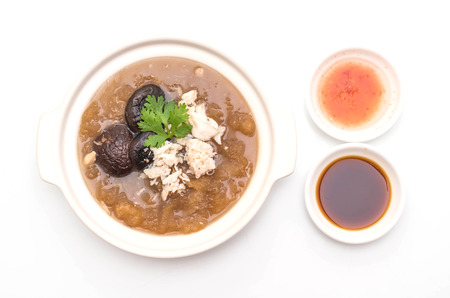 Braised Fish Maw in Red Gravy Soup with Crab in bowl isolated on white background