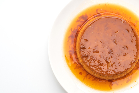homemade caramel custard pudding isolated on white backgroundの写真素材