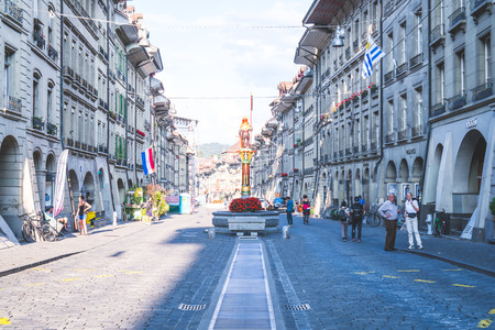 Bern, Switzerland - 23 AUG 2018: People on the shopping alley with the Zytglogge astronomical clock...