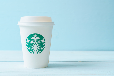 BANGKOK, THAILAND - JUN 5, 2018: White coffee cup with Starbucks logo on wood background. Starbucks is the world's largest coffee house with over 20,000 stores in 61 countries.のeditorial素材