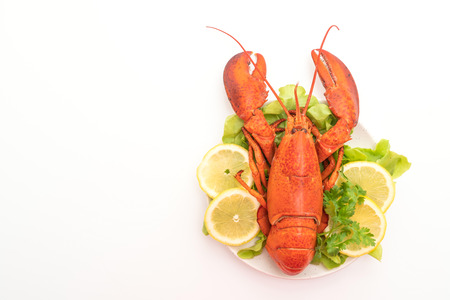 freshly boiled lobster with vegetable and lemon isolated on white backgroundの写真素材
