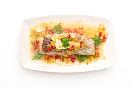 Steamed Grouper Fish Fillet with Chili Lime Sauce in lime dressing isolated on white background