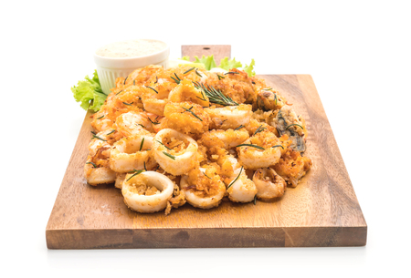 fried seafood (squids, shrimps, mussels) with sauce isolated on white backgroundの写真素材