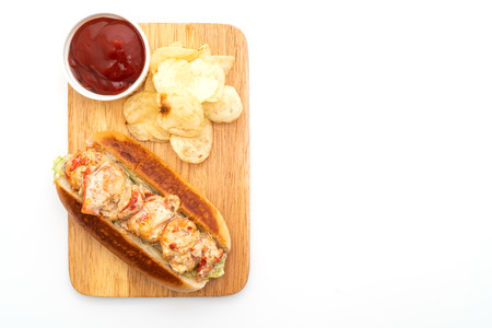 homemade lobster roll with potato chips isolated on white backgroundの写真素材