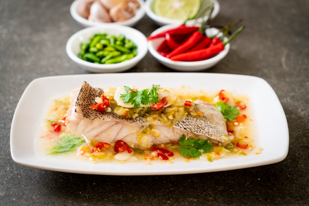 Steamed Grouper Fish Fillet with Chili Lime Sauce in lime dressing - Asian food styleの写真素材
