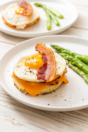 fried egg with bacon and cheese on pancake for breakfastの写真素材