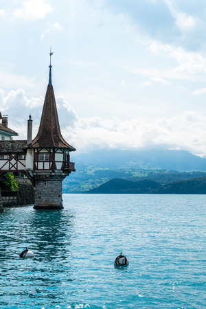 Beautiful Architecture at Oberhofen Castle with Thun Lake background in Switzerlandのeditorial素材