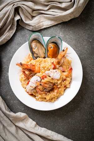 risotto with seafoods (shrimps, mussels, octopus, clams) and tomatoes - Italian food styleの写真素材