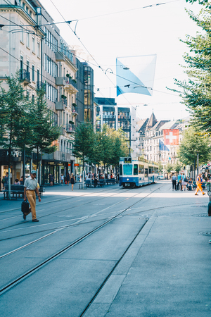 ZURICH, SWITZERLAND - AUG 23, 2018: A tram drives down the center of Bahnhofstrasse while people walk on the sidewalks in Zurich City, Switzerland.のeditorial素材