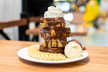 Waffle with banana slices and ice-creamの写真素材