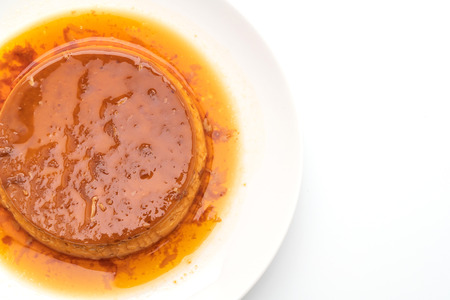homemade caramel custard pudding isolated on white backgroundの写真素材