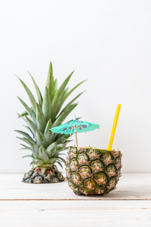 fresh pineapple smoothie glass on wood table - Healthy Drinkの写真素材