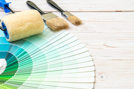 sample colors catalogue pantone or colour swatches book with paint roller brushの写真素材