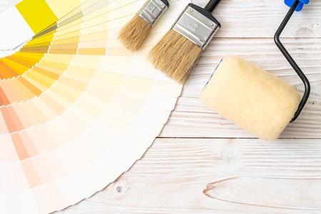 sample colors catalogue pantone or colour swatches book with paint roller brushの写真素材