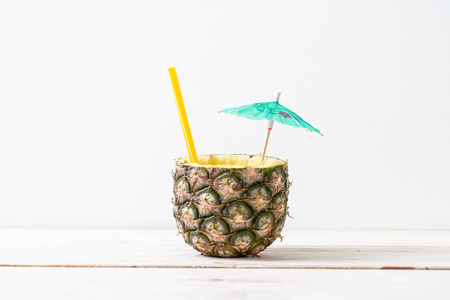 fresh pineapple smoothie glass on wood table - Healthy Drinkの写真素材