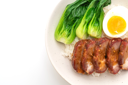 roast barbecue red pork on topped rice isolated on white backgroundの写真素材