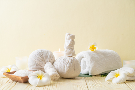 Spa herbal compressing ball with candle and orchid - beauty conceptの写真素材