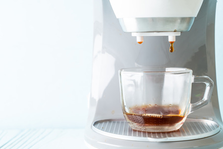 coffee maker machine making coffee on wood backgroundの写真素材