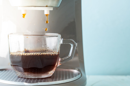 coffee maker machine making coffee on wood backgroundの写真素材