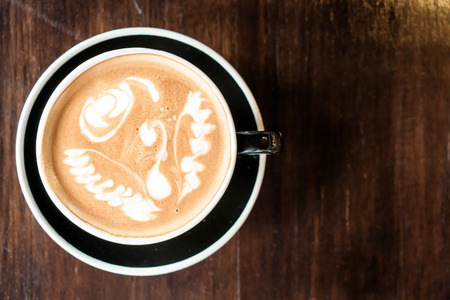 hot latte coffee cup in cafe restaurant - vintage effect filterの写真素材