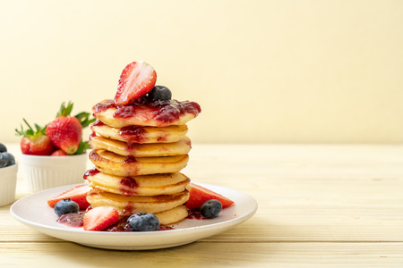 pancake with strawberries, blueberries and berry sauceの写真素材