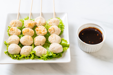 grilled pork meatballs with sweet chili sauce on plateの写真素材