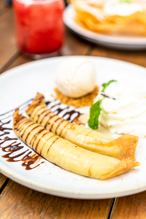 vanilla ice-cream with banana crape and whipped cream in cafe restaurantの写真素材